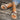 Women's trendy bohemian espadrille flat sandals featuring a colorful ankle chain, worn on a human leg, with visible toes against a wood background.