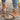 Women's bohemian espadrille flat sandals featuring a colorful ankle chain, styled with a casual outfit including jeans, highlighting a fashion-forward look.