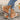 Trendy Bohemian espadrille flat sandals for women featuring a colorful ankle chain, shown in an orange hue on a woman's foot.