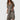 Woman wearing a trendy geometric print maxi dress with long sleeves, perfect for boho chic fall fashion.