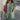 A woman standing and wearing a Trendy Geometric Print Maxi Dress with long sleeves, featuring a boho chic style perfect for fall fashion.