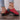 Trendy green women's flat sandals with bow-tie detail, designed for beachwear, shown on a model's feet.