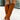 A pair of trendy tan suede knee-high high heel boots for women being worn, showcasing the knee and calf area. The boots are styled with an electric blue dress, highlighting the contrast between the tan suede and the blue fabric.