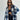 Trendy women's oversized plaid jacket in grey, featuring a collared neckline and long sleeves, styled for chic autumn streetwear. The model wears sunglasses, accentuating the fashionable outerwear look.