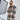 Stylish woman wearing an oversized plaid jacket with a tartan pattern, complemented by sunglasses, embodying chic autumn streetwear.
