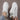 Trendy women's white low-top sneakers with gold accents showcasing a stylish design, suitable for outdoor activities and sportswear.