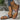 Tribal pattern women's sandals featuring a boho chic design, showcasing a colorful patterned strap suitable for summer wear. The sandal is modeled on a woman's foot, highlighting its stylish and fashionable appeal.