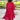 Woman wearing a Tropical Red Floral V-Neck Summer Dress standing in grassy field.