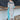A fashion model wearing a turquoise boho maxi kaftan with an exotic print, featuring long sleeves, a defined waist, and lightweight fabric, perfect as a beach cover-up or summer dress.