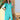 Turquoise linen summer dress with asymmetrical hem and long sleeves, displayed on a mannequin.