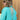 A turquoise linen dress featuring an asymmetrical hem and long sleeves, styled for summer wear.