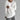 Unisex lightweight long-sleeve white crewneck t-shirt displayed on a person, showcasing the garment's fit on the shoulders and waist with visible sleeves.
