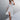 V-neck black and white polka dot wrap midi dress with short sleeves, cinched waist, and knee-length hem, suitable for summer fashion.
