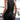 A woman wearing a versatile sleeveless black racerback dress that is casual and lightweight for summer wear.