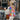 Model wearing a vibrant multicolor patchwork Boho chic Granny Square wool cardigan in white, size L, standing with a relaxed pose.