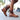 Brown distressed leather lace-up boots with side zipper, showcased on a wooden surface, displaying a vintage and fashionable style.