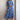 Whimsical blue maxi dress with colorful embroidery and intricate patterns, featuring a flowing design and vibrant accents, perfect for daytime wear.