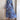 Whimsical blue maxi dress featuring colorful embroidery and intricate patterns, with a flowing design and long sleeves.