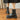 White chunky platform ankle boots for women with a zipper, worn by a person standing on a wooden floor, paired with a dress.