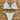 Handmade white crochet bikini with adjustable triangle top and tie-side bottoms displayed on a clothes hanger.