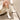 White embroidered women's western cowboy boots featuring intricate patterns. The boots are stylish and chic, offering a fashionable western look. They have a comfortable design suitable for long wear and are displayed on a wooden floor.