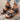 White floral wedge sandals featuring a beaded strap and intricate cutout design.