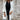 A stylish women's white fringed cardigan suitable for fall fashion, featuring long sleeves and a collar, worn over a dress shirt.