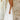 Elegant white halterneck tiered midi dress, featuring a sophisticated design suitable for summer resort wear. The dress is sleeveless, highlighting the shoulders and neck, perfect for bridal parties or elegant occasions.