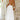 White halterneck tiered midi dress displayed on a model, showcasing its elegant design suitable for summer resort wear, with a focus on the dress's flowing silhouette and stylish halterneck neckline.