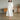 White linen midi dress featuring a V-neckline, pleated details, and long sleeves, designed with sustainability in mind.