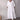White linen V-neck mid-length dress with short sleeves, showcasing a casual and stylish summer outfit.