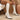 White ribbed high heel sock boots with a block heel design, featuring a stylish winter look. The boots are shown in a white color, highlighting their textured textile material and sleek silhouette.