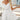 White sleeveless backless A-line mini summer dress for women, showcasing a stylish and elegant design with a fitted waist and flowing skirt.