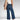 Casual chic outfit featuring wide-leg high-waisted jeans in denim and a neutral grey blazer with a collar, paired with a sleeveless shirt.