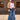 Casual chic outfit featuring wide-leg high-waisted jeans paired with a neutral blazer, accessorized with sunglasses and a stylish bag.