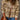 Women's Aztec Quarter Zip Geometric Knit Sweater in a cozy boho style, featuring a geometric pattern with a warm orange hue. The pullover design includes a quarter zip neckline, long sleeves, and a comfortable fit, ideal for casual outerwear.