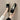 Women's slip-on loafers with beaded detailing, shown on a person wearing a summer outfit. The loafers feature a flat sole and elegant design, suitable for a casual yet stylish look.