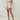 Women's beige high-waisted summer shorts made of lightweight textured cotton, showing a close-up of the waist and thigh area.