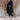 Women's beige hooded puffer vest, sleeveless winter coat, displayed on a person standing, showcasing its fashionable design and waist-length fit.