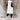 Women's beige hooded puffer vest styled as a sleeveless winter coat, worn by a standing person, showcasing its comfortable fit around the shoulder and waist.