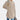 Women's beige long sleeve tunic sweater with a high neck and loose fit design.