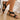 Women's black wedge sandals with embroidered floral design, showcasing a comfortable and elegant style. The sandals feature a wooden wedge heel and a closed toe design, highlighting the detailed craftsmanship.