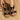 Women's black wedge sandals with elegant floral embroidery, featuring a comfortable fit and beige sole, worn on a person's foot.