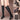 Women's black knee-high leather boots with tassel detailing and block heel, showcasing a fashionable design on a human leg.