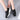 Women's black leather platform loafers showcasing a sleek and stylish design with a comfortable fit.