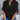 Women's black V-neck split sleeve blouse worn by a model, paired with jeans. The blouse is elegant and suitable for summer workwear, highlighting the shoulders and featuring a fashionable design.