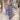 Women's blue floral wide-leg jumpsuit with a resort fashion style, featuring a vibrant floral pattern and a relaxed fit suitable for warm weather outings.