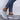 Women's breathable mesh slip-on sneakers in a casual style, shown on a person wearing blue jeans.