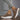 Women's brown platform sneakers with trendy lace-up design and ankle support, showcased on a model. The sneakers are paired with light-colored clothing, emphasizing their casual yet stylish appeal.