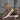 Women's brown platform sneakers with trendy lace-up design and ankle support, featuring beige and white tones, displayed in a fashionable setting.